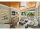 Inviting sunroom with wood ceiling, brick accent wall, and comfortable seating area at 2101 Dilworth W Rd, Charlotte, NC 28203