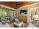 Cozy sunroom with ample seating, ceiling fan, television, and natural light at 2101 Dilworth W Rd, Charlotte, NC 28203