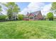 Expansive backyard with mature trees, privacy fence, and patio at 2104 Planters Knoll Dr, Monroe, NC 28110
