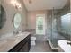 Luxurious bathroom with dual vanity, freestanding tub, and glass-enclosed shower at 2104 Planters Knoll Dr, Monroe, NC 28110