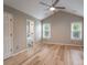 Primary bedroom with vaulted ceiling, hardwood floors, ceiling fan, and ensuite bath at 2104 Planters Knoll Dr, Monroe, NC 28110