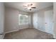 Cozy bedroom with neutral carpet, ceiling fan, and large window at 2104 Planters Knoll Dr, Monroe, NC 28110