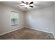 Another carpeted bedroom with ceiling fan and good natural light at 2104 Planters Knoll Dr, Monroe, NC 28110