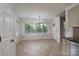 Bright dining room features large windows, chandelier, and neutral tile floor at 2104 Planters Knoll Dr, Monroe, NC 28110