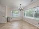 Spacious dining area with tile floors, chandelier, and lots of natural light at 2104 Planters Knoll Dr, Monroe, NC 28110