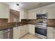 Modern kitchen featuring stainless steel appliances, granite countertops, and tile backsplash at 2104 Planters Knoll Dr, Monroe, NC 28110