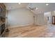 Spacious living room with hardwood floors, stone fireplace, vaulted ceiling, and ceiling fan at 2104 Planters Knoll Dr, Monroe, NC 28110