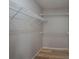Walk-in closet with built in shelving and hardwood flooring at 2104 Planters Knoll Dr, Monroe, NC 28110