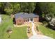 An aerial shot of a well-maintained brick home with manicured landscaping and a winding walkway at 2121 Arnold Dr, Charlotte, NC 28205