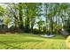 The backyard features a firepit area, raised garden beds and lush green space at 2121 Arnold Dr, Charlotte, NC 28205