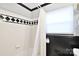 Modern bathroom features a shower with black and white tile accent wall at 2121 Arnold Dr, Charlotte, NC 28205