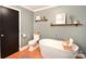 Well-appointed bathroom with a standalone tub, toilet, and open shelving for storage at 2121 Arnold Dr, Charlotte, NC 28205