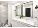 Beautiful bathroom with double vanity, modern mirrors, and walk-in shower with glass doors at 2121 Arnold Dr, Charlotte, NC 28205