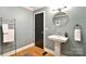 Elegant bathroom featuring a pedestal sink, modern fixtures, and hardwood flooring at 2121 Arnold Dr, Charlotte, NC 28205