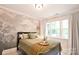 Serene bedroom featuring a comfortable bed and natural light from the large window at 2121 Arnold Dr, Charlotte, NC 28205