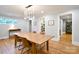 Bright dining room featuring hardwood floors, modern chandelier, and convenient access to the pantry at 2121 Arnold Dr, Charlotte, NC 28205