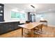Modern kitchen with dark cabinets, stainless steel refrigerator, a wooden table, and lots of natural light at 2121 Arnold Dr, Charlotte, NC 28205