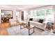 Open-concept living room featuring a large window, hardwood floors, and comfortable, modern furniture at 2121 Arnold Dr, Charlotte, NC 28205