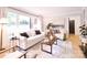 Well-lit living room showcasing stylish furniture, a large window, and a view into adjacent rooms at 2121 Arnold Dr, Charlotte, NC 28205