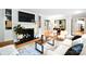 Cozy living room with a fireplace, built-in shelves, hardwood floors, and stylish furniture at 2121 Arnold Dr, Charlotte, NC 28205