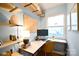 Bright office space featuring custom shelving, desk, and natural light from large window at 2121 Arnold Dr, Charlotte, NC 28205