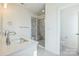 Bright bathroom featuring a double sink vanity, marble-tiled shower, and separate toilet room at 2124 Barrowcliffe Nw Dr, Concord, NC 28027