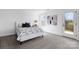 Bright bedroom with carpeted floors and a door leading to outdoor view at 2124 Barrowcliffe Nw Dr, Concord, NC 28027