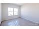 Bright bedroom with double windows and carpet floors offers a comfortable space for relaxation at 2124 Barrowcliffe Nw Dr, Concord, NC 28027