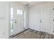 Bright entryway showcasing a white door with sidelights and wood-look flooring at 2124 Barrowcliffe Nw Dr, Concord, NC 28027
