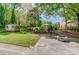 Spacious backyard featuring lush landscaping, a storage shed, and a fire pit area at 2221 Hamilton Mill Rd, Charlotte, NC 28270