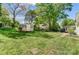 Large backyard with a wooden storage shed, mature trees, and well-maintained lawn at 2221 Hamilton Mill Rd, Charlotte, NC 28270