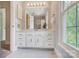 Well-lit bathroom with white vanity, marble floor, and a window with a view at 2221 Hamilton Mill Rd, Charlotte, NC 28270