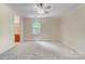 Open bedroom area leading to the bathroom, features carpet floors and natural light at 2221 Hamilton Mill Rd, Charlotte, NC 28270