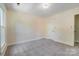 Spacious bedroom featuring neutral walls, plush carpet, and a door leading to the hallway at 2221 Hamilton Mill Rd, Charlotte, NC 28270