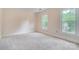 Bright bedroom featuring neutral walls, plush carpeting, and two windows offering ample natural light at 2221 Hamilton Mill Rd, Charlotte, NC 28270