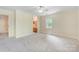 Carpeted bedroom leading to a bathroom, features ample natural light at 2221 Hamilton Mill Rd, Charlotte, NC 28270