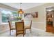 Bright breakfast nook with a glass table, comfortable chairs, and natural light from a large window at 2221 Hamilton Mill Rd, Charlotte, NC 28270
