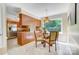 Sunlit breakfast nook showcasing a glass table, wood cabinets, and a large window with a scenic view at 2221 Hamilton Mill Rd, Charlotte, NC 28270