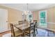 Dining room featuring stylish table, chairs, chandelier, and natural light from the large windows at 2221 Hamilton Mill Rd, Charlotte, NC 28270