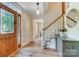 Foyer with hardwood floor, stained glass sidelights, elegant pendant light, and staircase at 2221 Hamilton Mill Rd, Charlotte, NC 28270