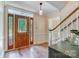 Foyer with a hardwood floor, stained glass sidelights, elegant pendant light, and staircase at 2221 Hamilton Mill Rd, Charlotte, NC 28270