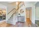 Inviting foyer featuring hardwood floors, staircase, and an elegant pendant light at 2221 Hamilton Mill Rd, Charlotte, NC 28270