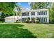Charming two-story home with a lush green lawn, attached two-car garage, and traditional black shutters at 2221 Hamilton Mill Rd, Charlotte, NC 28270