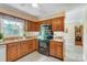 Well-equipped kitchen with stainless steel appliances, wood cabinets, granite countertops, and tiled floors at 2221 Hamilton Mill Rd, Charlotte, NC 28270