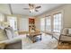 Comfortable living room featuring French doors leading to an outdoor area, with a wet bar and a ceiling fan at 2221 Hamilton Mill Rd, Charlotte, NC 28270
