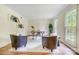 Bright home office with hardwood floors, two chairs, a desk, and natural light from large windows at 2221 Hamilton Mill Rd, Charlotte, NC 28270