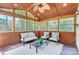 Cozy sunroom filled with natural light, comfortable seating, and a ceiling fan at 2221 Hamilton Mill Rd, Charlotte, NC 28270
