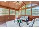 Bright sunroom with wood paneling, comfortable seating, and multiple windows at 2221 Hamilton Mill Rd, Charlotte, NC 28270