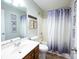 Charming bathroom with decorative shower curtain and rustic wood accents at 260 Ingonish Dr, Gastonia, NC 28056