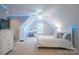 Bright bedroom featuring lighted vaulted ceiling, carpet, and accent furniture at 260 Ingonish Dr, Gastonia, NC 28056